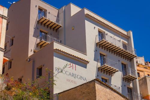 a building with a sign for the carolina hotel at RoccaRegina Hotel in Sciacca