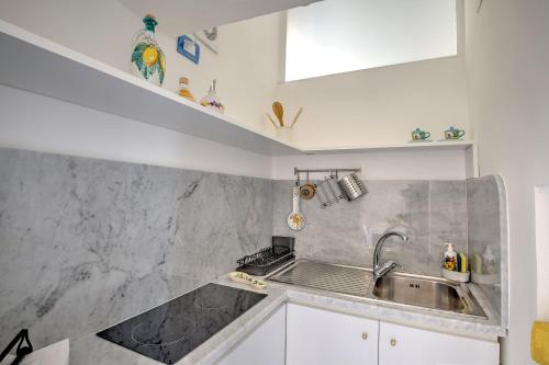 a kitchen with a sink and a counter top at MariLeo Amalfi in Amalfi