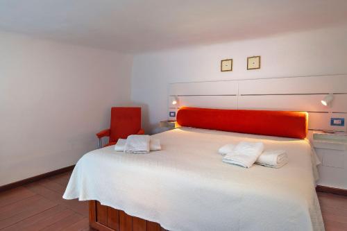 a bedroom with a large white bed with a red headboard at MariLeo Amalfi in Amalfi