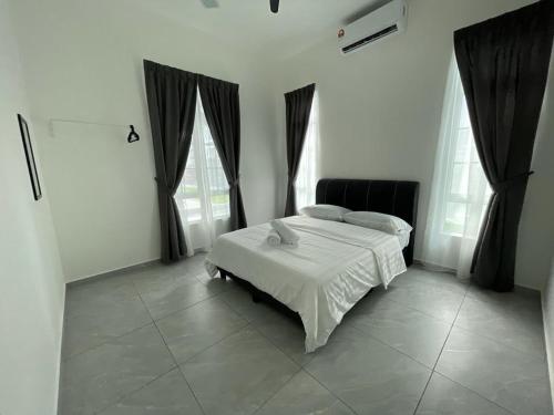 a bedroom with a white bed and two windows at De France Pool Villa Mu5lim Only in Malacca