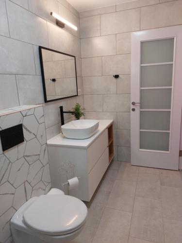 a white bathroom with a sink and a toilet at Lishansky Since 1936 in Metulla