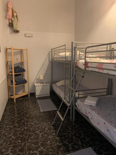 a room with three bunk beds and a staircase at Casa Monte da Eira in Giões