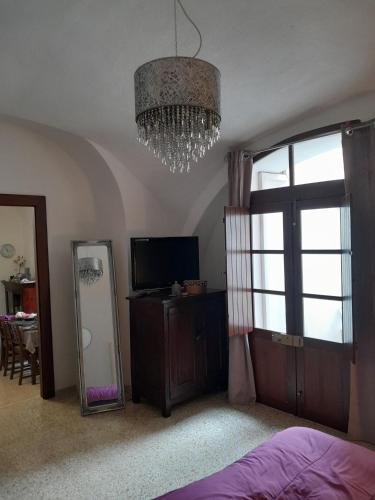 a bedroom with a mirror and a chandelier at Da Julia in Oristano