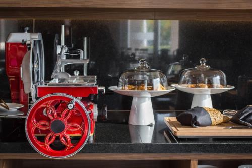a counter with two plates of food and a red wheel at AC Hotel by Marriott Guadalajara Expo in Guadalajara