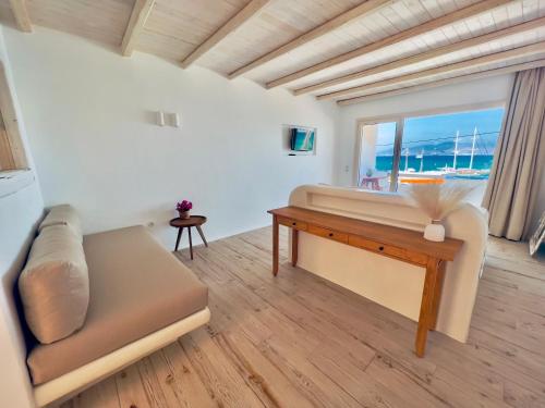 a living room with a couch and a table at Apartments enosis, Poseidon in Agia Anna Naxos