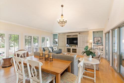 a living room with a table and a couch at After Dune Delight - 626 Beachview Drive in Saint Simons