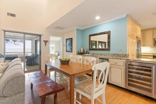 a kitchen and dining room with a table and chairs at After Dune Delight - 626 Beachview Drive in Saint Simons