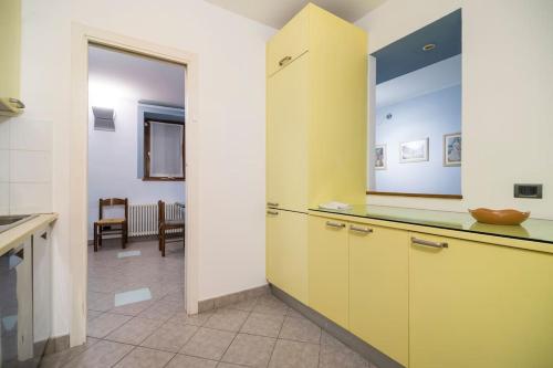 a kitchen with yellow cabinets and a counter top at Casa Anita in Mergozzo