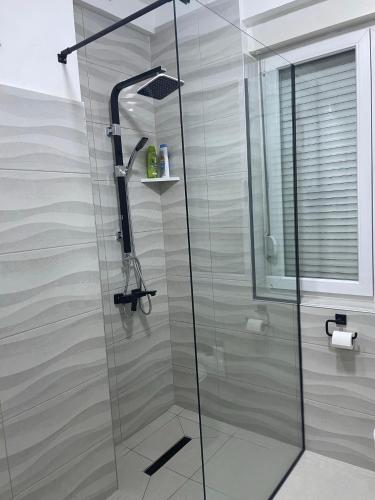 a shower with a glass door in a bathroom at Modern & cozy 2-bedroom vacation home in Sarajevo in Sarajevo