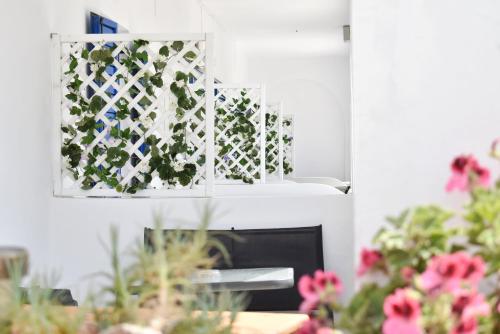 a living room with flowers and a fireplace at Tzamaros Studios in Mérikhas