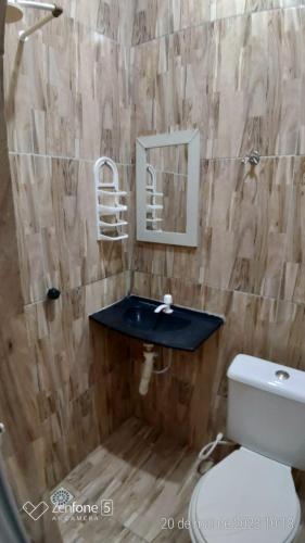 a bathroom with a sink and a toilet at CANTINHO SÃO PEDRO in Maceió