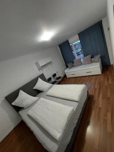 a bedroom with a large bed and a living room at Apartma Sandi in Šentilj