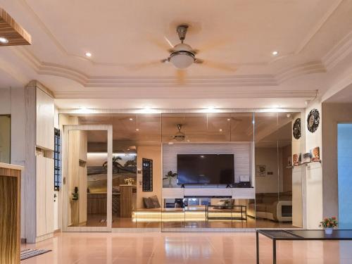 a large living room with a large tv on the wall at Pool Villa Max Bath Tub BBQ Steamboat Party 5Bedroom 23Pax Full Airconditioned in Melaka