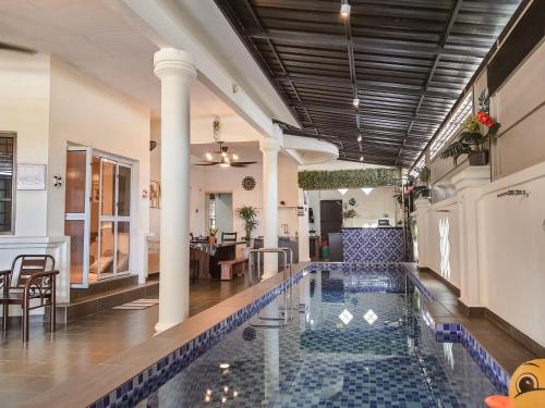 a pool in the middle of a building with a lobby at Pool Villa Max Bath Tub BBQ Steamboat Party 5Bedroom 23Pax Full Airconditioned in Melaka