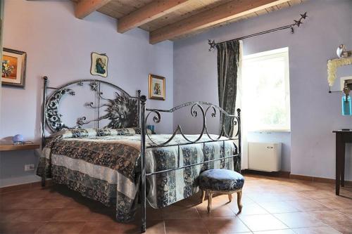 a bedroom with a metal bed and a window at Agriturismo Colle delle Stelle in Mergo