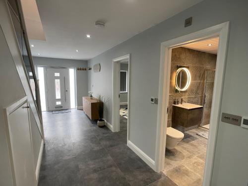 a bathroom with a toilet and a sink at Newly refurbished 4 Bedroom House-Sleep 8-Free parking in Canvey