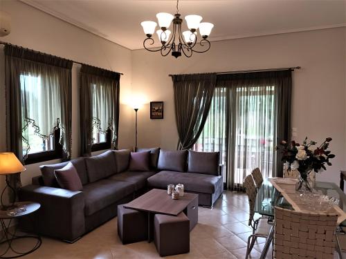 a living room with a couch and a table at ZENIA Pelion garden house in Platanidia