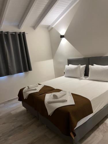 um quarto com uma cama com duas toalhas em Saint Spiridon Hotel em Kassiopi