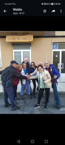 a group of people standing in front of a building at Pensión Casa do Gallo Sarria in Sarria