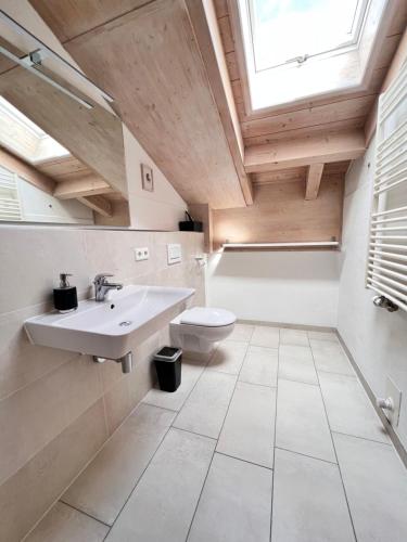 a bathroom with a sink and a toilet at Gästehaus Bergwinkl in Reit im Winkl