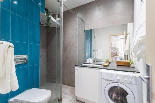 a bathroom with a washing machine and a sink at Lisbon Mouraria Apartment in Lisbon
