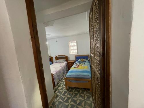 a small room with a bed and a small bedroom at Au cœur du Médina in Fez