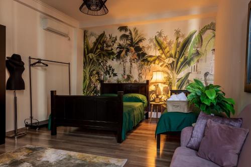 een woonkamer met een bed en een bank bij The Tropical House Tirana in Tirana