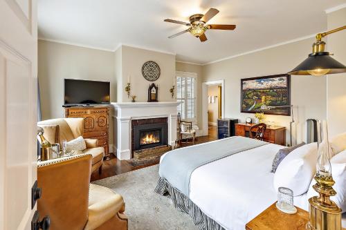 a bedroom with a bed and a fireplace at McCully House Inn in Jacksonville