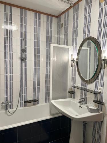 a bathroom with a sink and a mirror at Belvedere da Cesarina in Tarvisio
