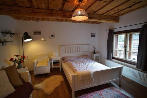 a bedroom with a bed and a desk and a window at Drevenica Harmony so saunou in Ružomberok