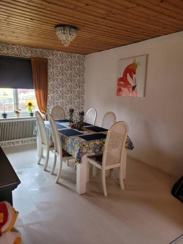 a dining room with a table and chairs at Stuga Ani in Svartå