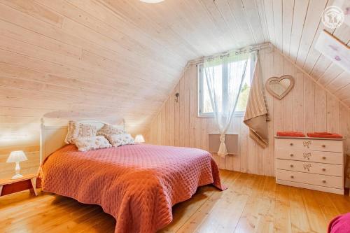 a bedroom with a bed in a attic at Gîte de la Colombière in La Grande-Verrière