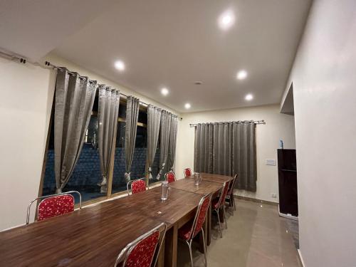a conference room with a long table and chairs at Honey Bee in Leh