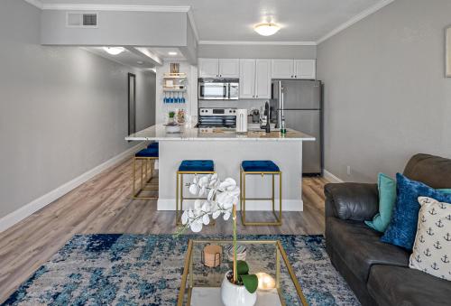 a living room with a couch and a kitchen at Wake up to the ocean breeze - Enjoy amazing views in Tampa