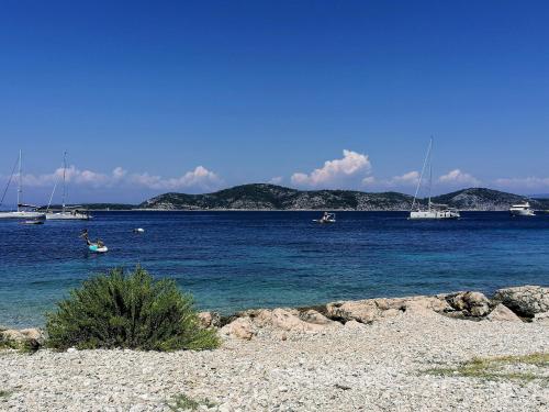 a beach with boats in a body of water at B&B Paradiso - Pakleni Islands Hvar in Hvar