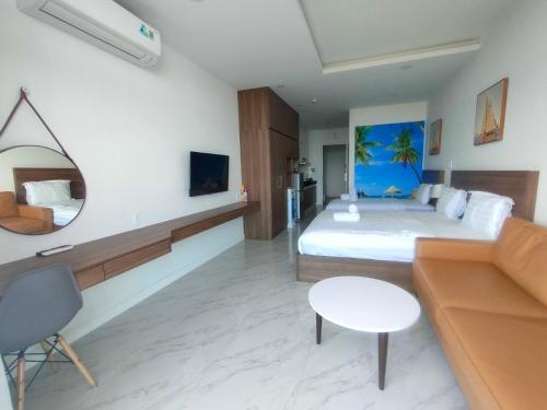 a hotel room with a bed and a couch at Hotel,Căn Hộ Mũi Né Sea link in Phan Thiet