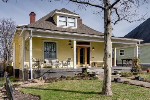 a yellow house with a porch with a table and chairs at Captain's Quarters East Nashville, Tn (Five Point) in Nashville