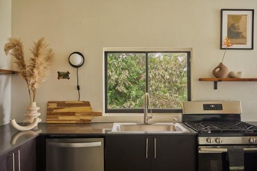 a kitchen with a sink and a window at WALD HAUS by DW in Naguabo