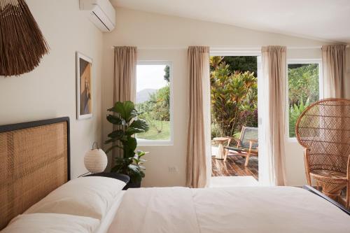 a bedroom with a bed and a view of a patio at WALD HAUS by DW in Naguabo