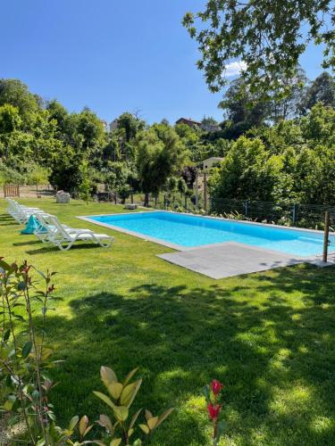 a swimming pool in the yard of a house at Ri&Vale Alojamentos in Vieira do Minho