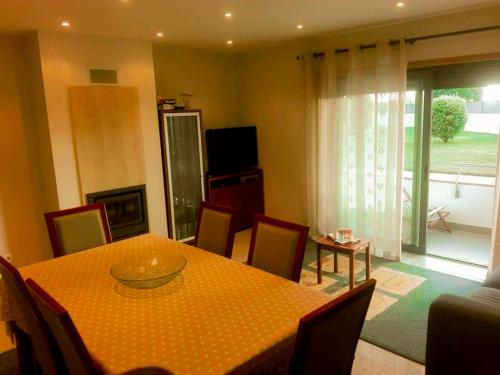 a dining room with a table and chairs and a room at BEACH FRONT APARTMENT - with swimming pool, barbecue and tennis court! in Viana do Castelo