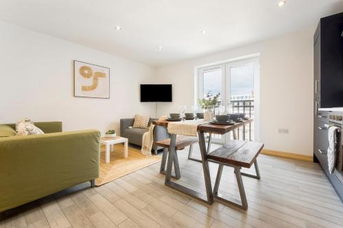 a living room with a table and a dining room at Spacious, newly renovated, three bedroom TOWN CENTRE duplex apartment with free parking, sleeps seven - Walking distance to beach in Bournemouth