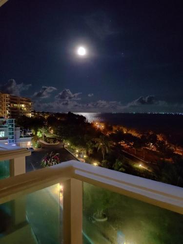 a view from a balcony at night with a full moon at Hotel,Căn Hộ Mũi Né Sea link in Phan Thiet