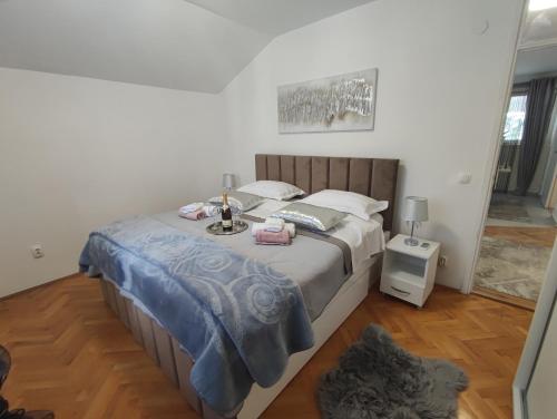 a bedroom with a large bed with a table on it at Apartman Oaza - Ploče, Croatia in Ploče