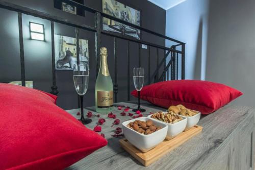 a table with a bottle of champagne and wine glasses at Capitain*s House in Šibenik