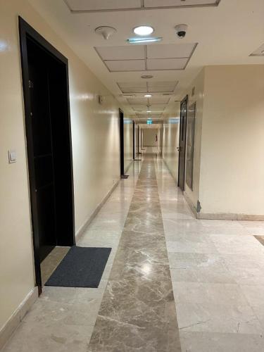 a hallway of an office building with a long hallway at Master bedroom attach toilet in Dubai