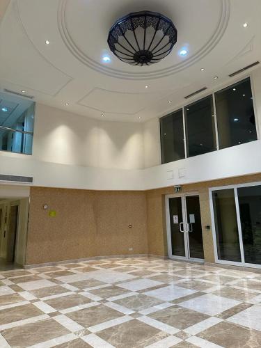an empty lobby with a large room with a ceiling at Master bedroom attach toilet in Dubai