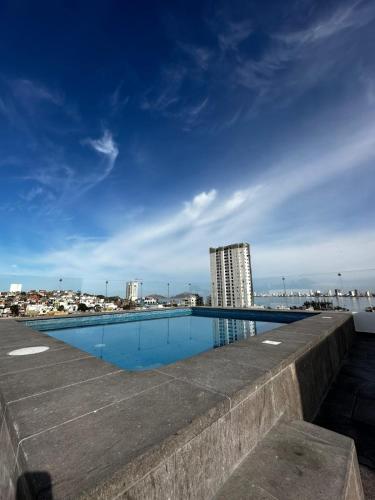 a swimming pool on the roof of a building at Departamento en Mazatlán Torre Zuñiga in Mazatlán