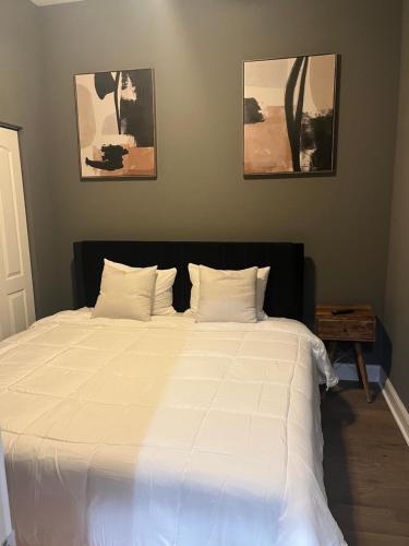a bedroom with a large bed with white sheets at Rustic Mix in Chicago