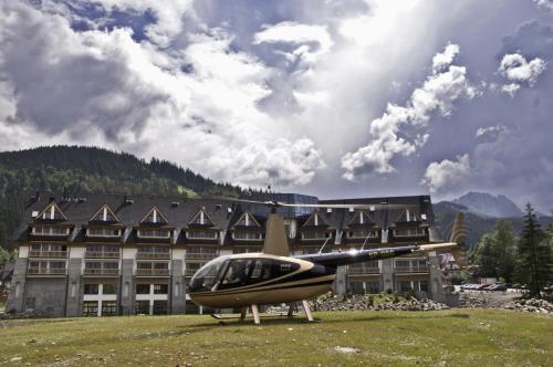 a small helicopter parked in front of a building at Grand Nosalowy Dwór in Zakopane